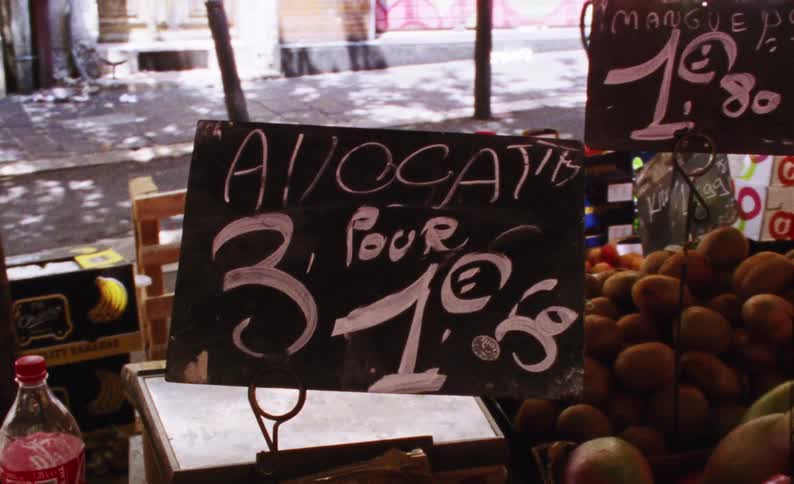 Grocery store with baskets of fresh fruits and prices