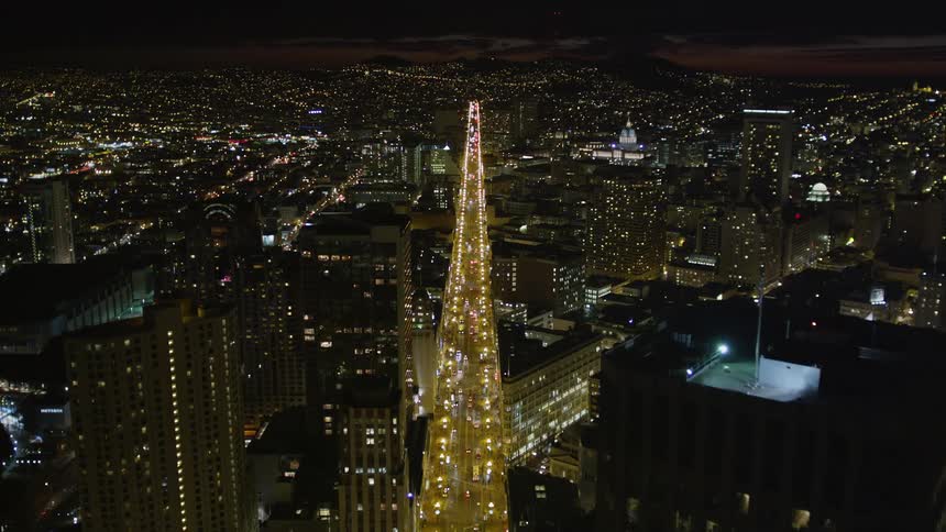 A major street with traffic in the middle of a city downtown