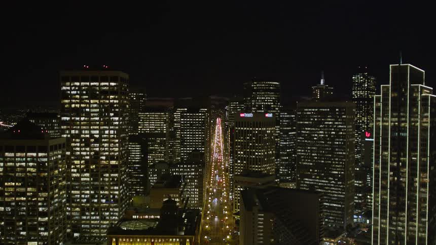 Aerial panorama of a metropolis with large urban and residential buildings with lighting at night and on the seafront