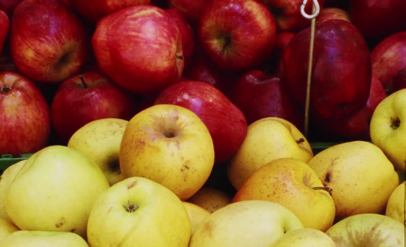 Crates full of apples are at the market