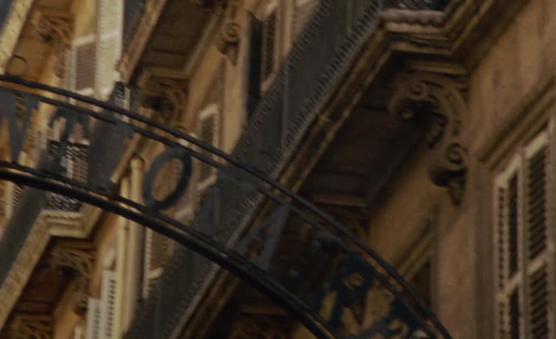 Arch with sign connecting two rustic urban buildings