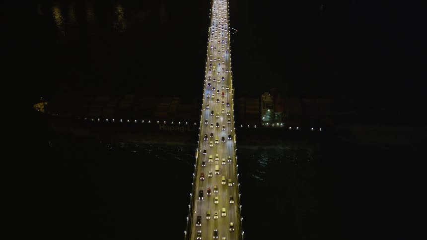 Traffic travels on the bridge at night