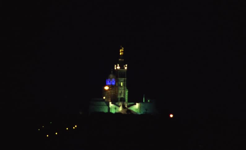 Exterior architecture of a tower of a cathedral with a view at night