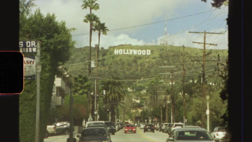 A shot of the street panning up to reveal the hollywood sign on the hollywood hills