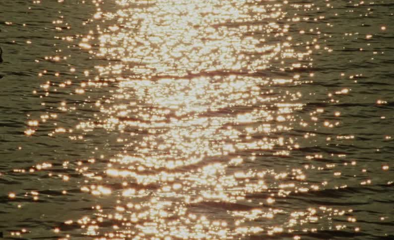 Reflection of sunlight on calm sea waves