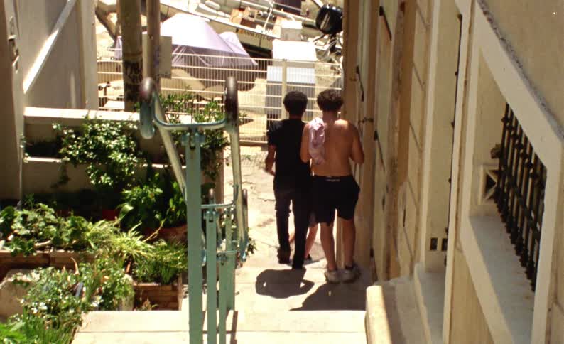 A clip back clip of male friends walking down the stairs