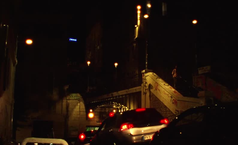 City street at night with vehicle and pedestrian traffic