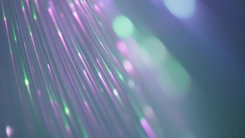 Long bright strands changing color by abstract lights