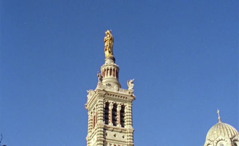 A large church has a statue on top of its tower
