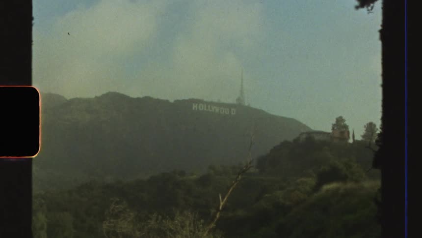 A distant view of the hollywood sign caught on vintage film