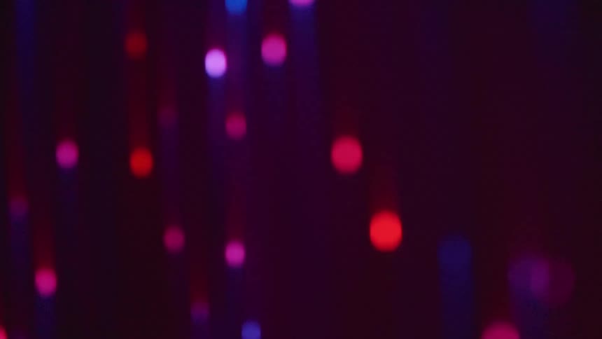 Long wires with lights changing color in an abstract way