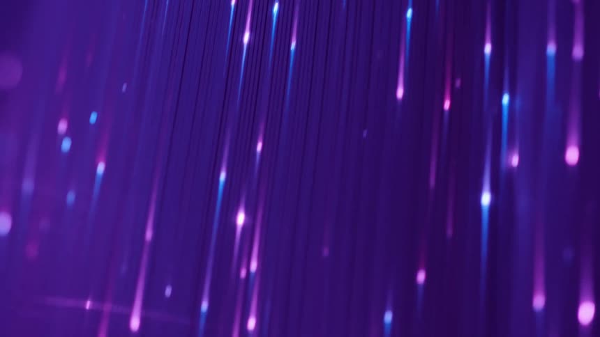Several blue and violet lights passing quickly on a background of the same tones