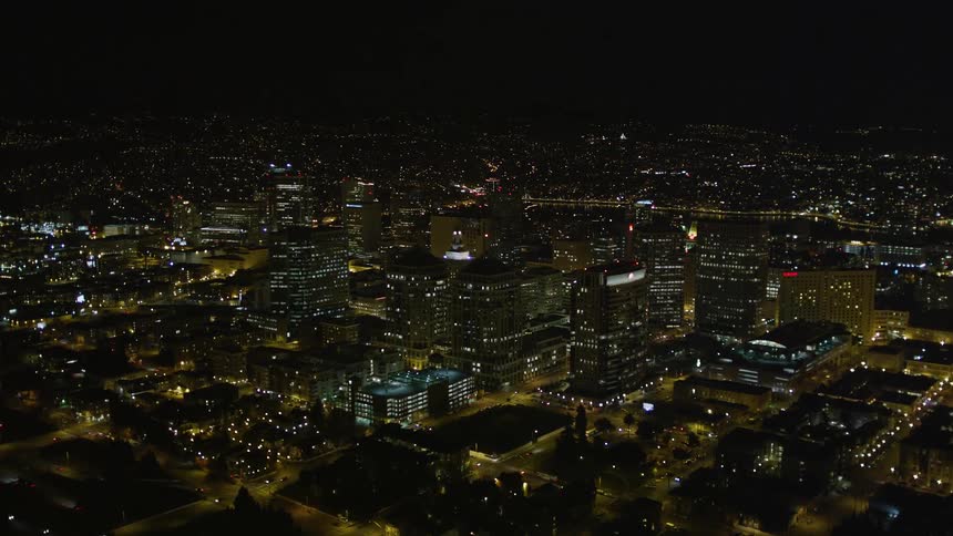 Aerial scenery of a metropolis illuminated at night with vehicle traffic