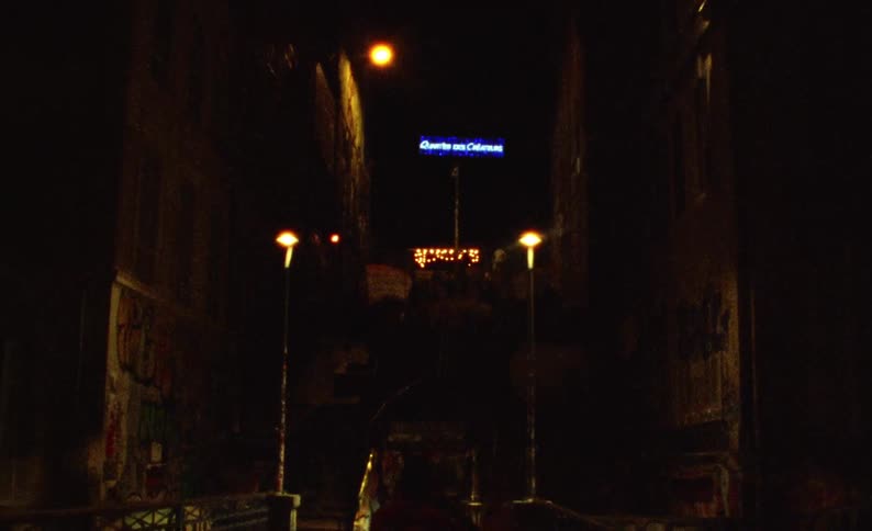 Silhouette of a person walking down an alley on a dimly lit suburban street