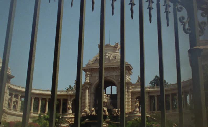 The palais longchamp in marseille seen behind the gated fence