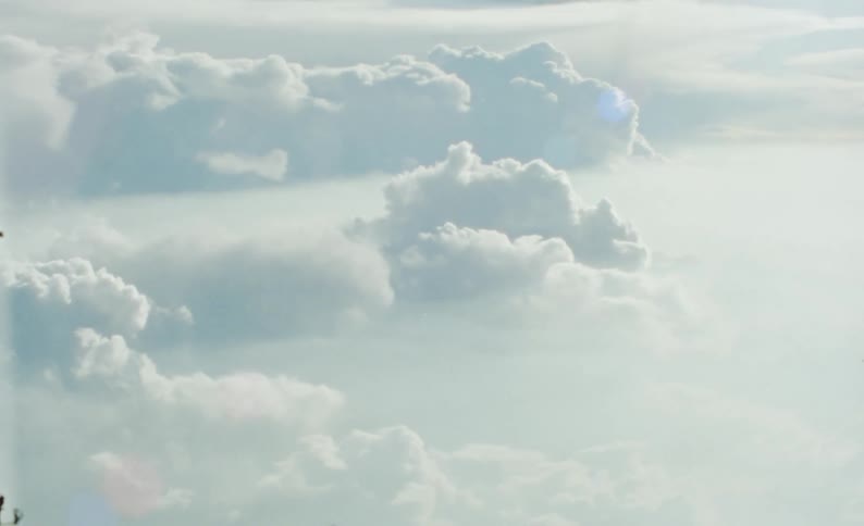 Aerial view of clouds illuminated by the sun caught on vintage film