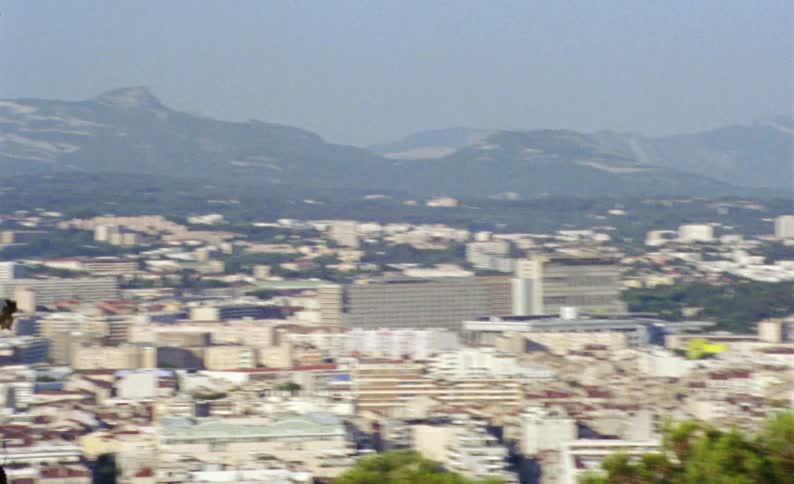 A panoramic view of a city with several whitecolored buildings