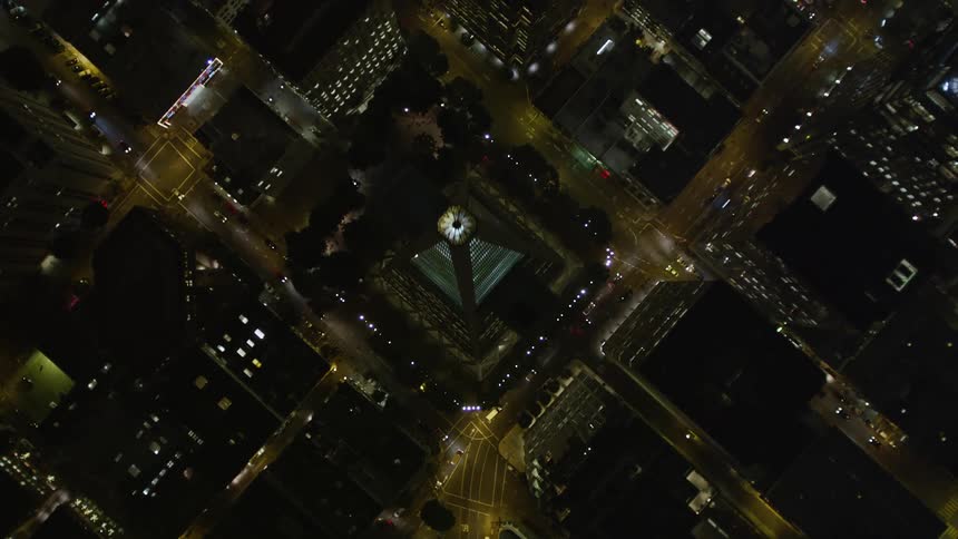 A road runs through a downtown city area complete with skyscraper
