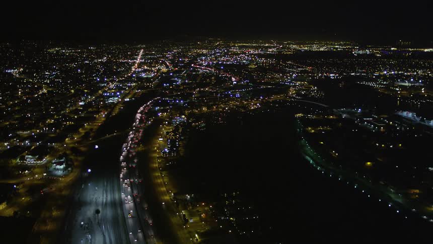 Traffic runs on the freeway through the city