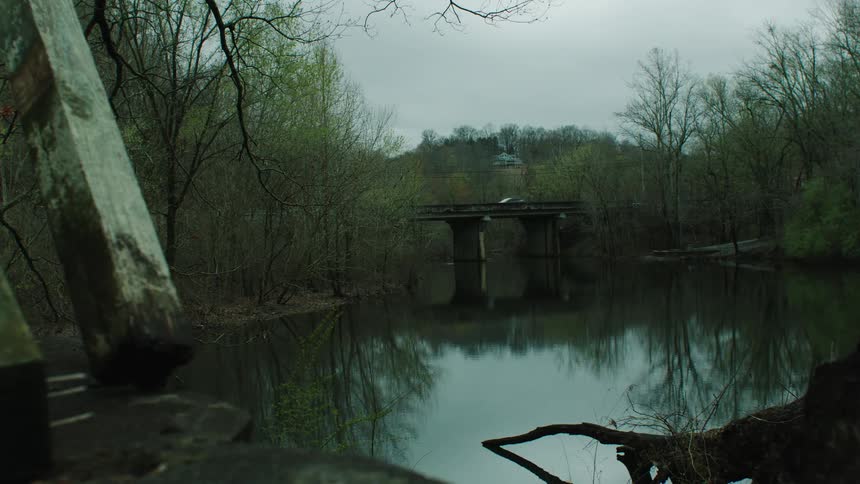 The car drives over the bridge