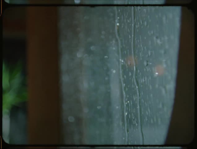 Rain drops flow down foggy window during a rainstorm
