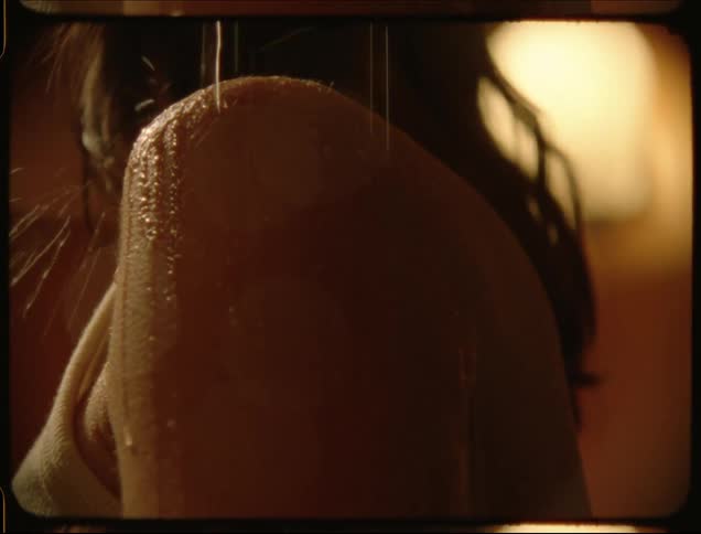 Drops of water falling on a womans shoulder