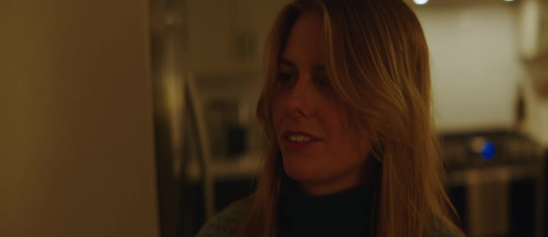 Portrait of a woman talking and walking indoors through the kitchen