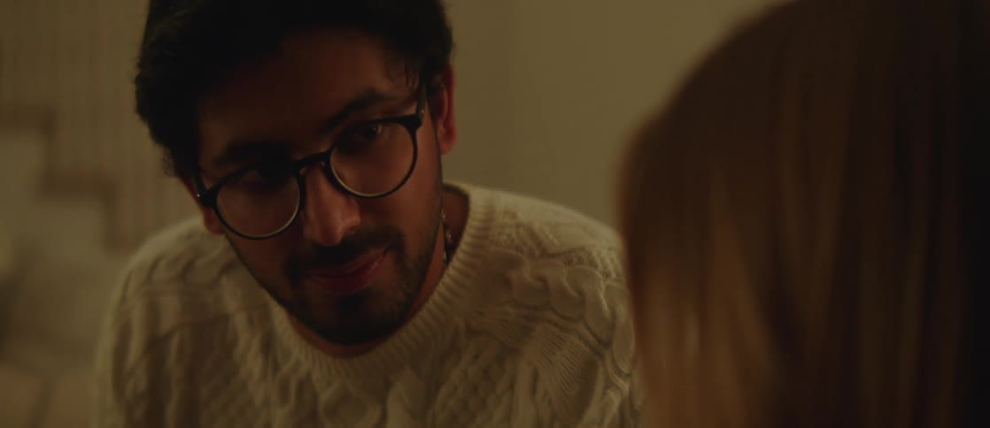 Portrait of a man talking to a woman while sitting indoors