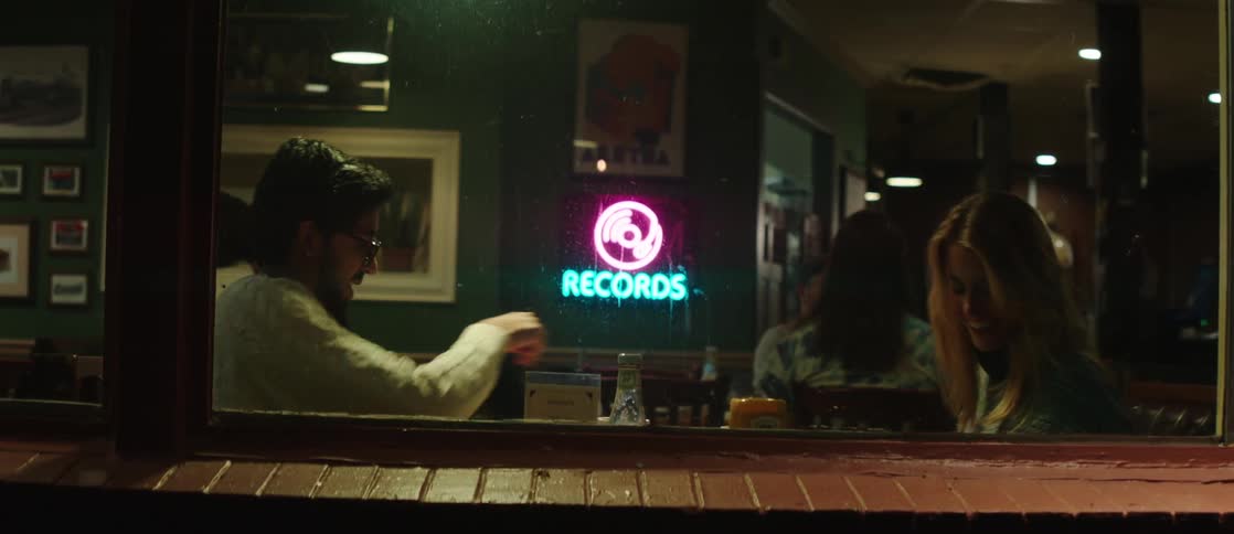 A couple is at a restaurant table talking near a window and then they get up and leave