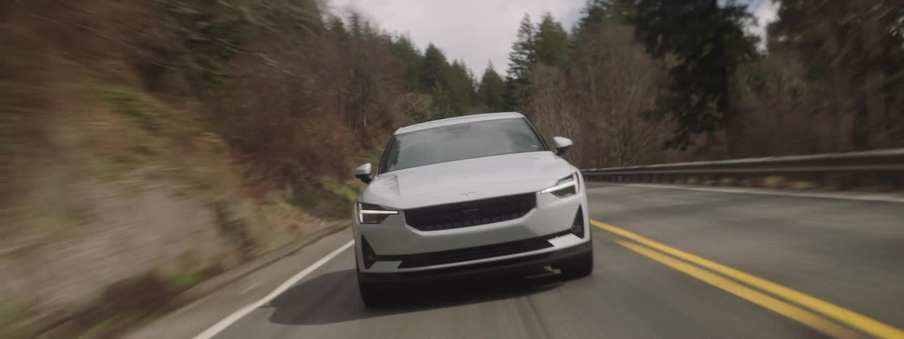 A car driving fast on a road through the mountains