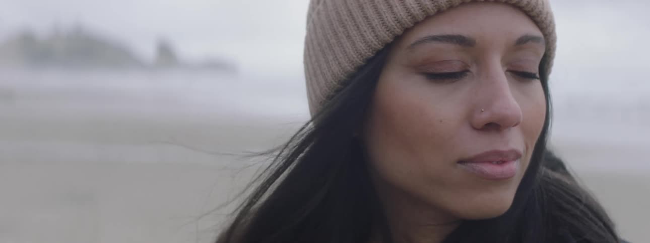 A woman is standing on the beach