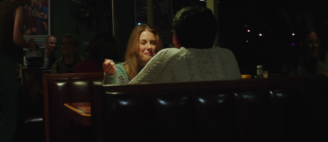 A young couple enjoy dinner in a cozy restaurant