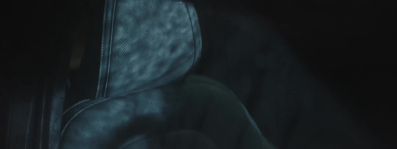 Rain casts shadows onto car seats at night