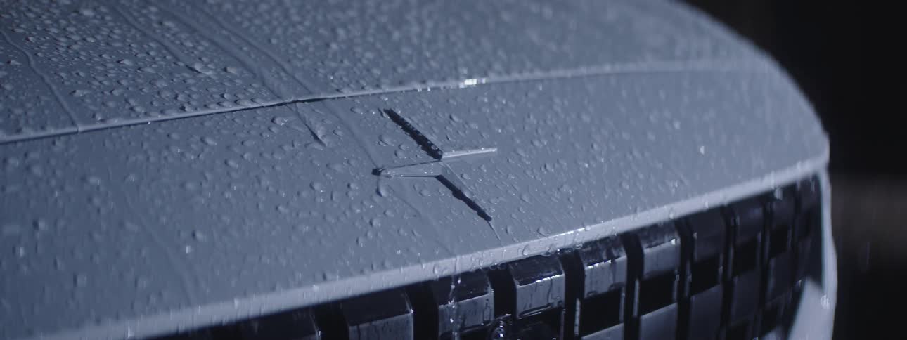 Rain runs off the hood of a car