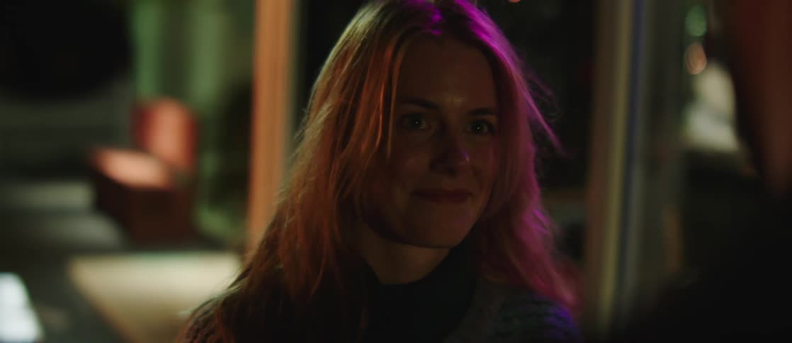 A woman smiles at a man and walks off with him
