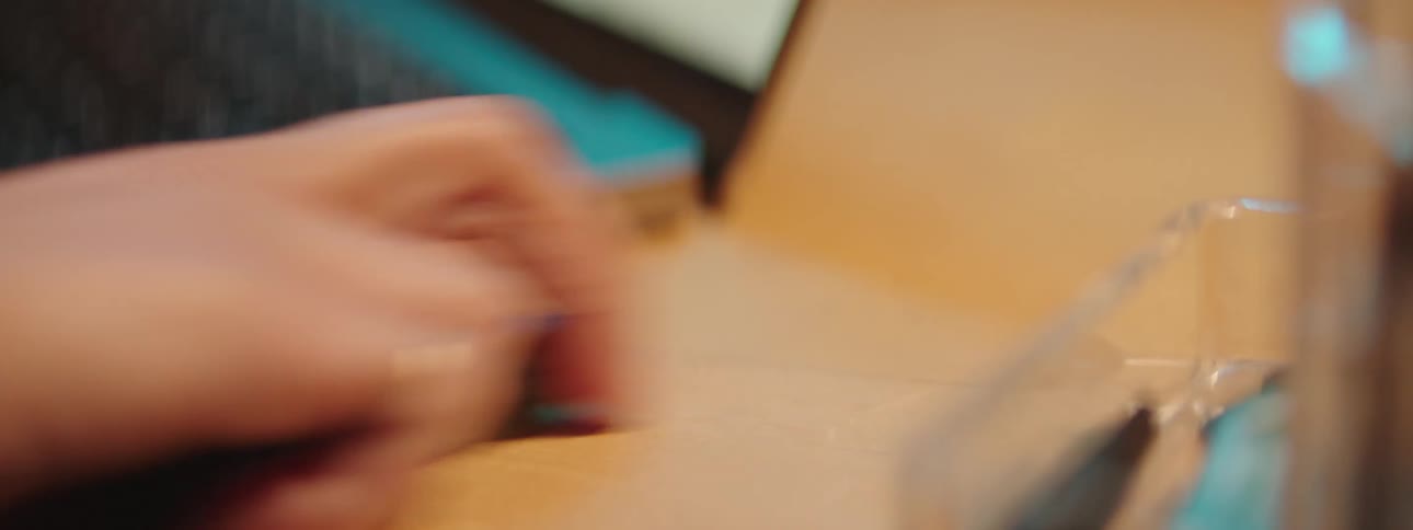 Womans hand picking up a key from a counter in the office