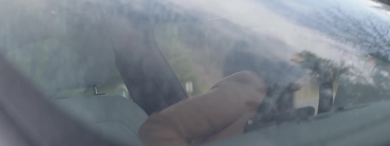 A woman opens her car door and gets out