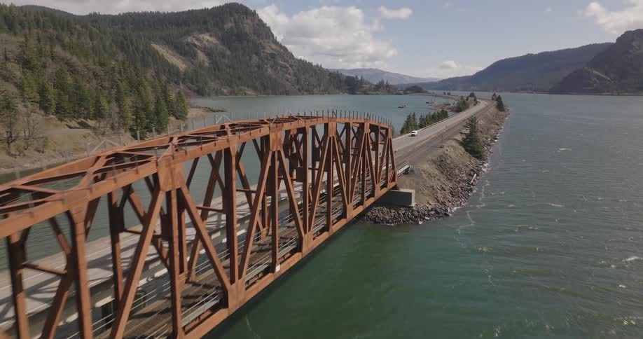 A car drives over a bridge in a remote area