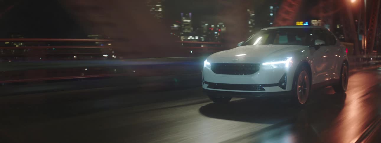 A car drives on a bridge in a big city