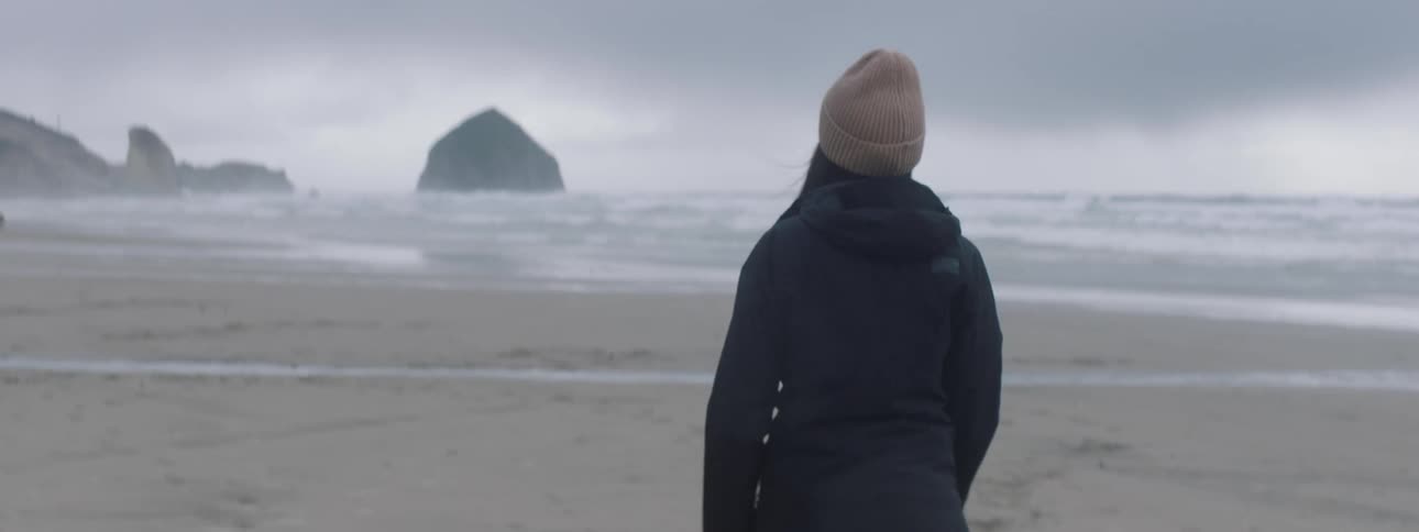 A woman is walking on the beach