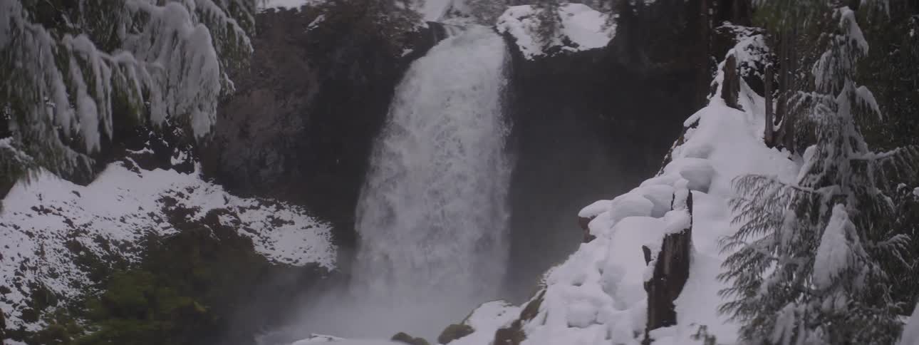Waterfall in the middle of a snowy forest