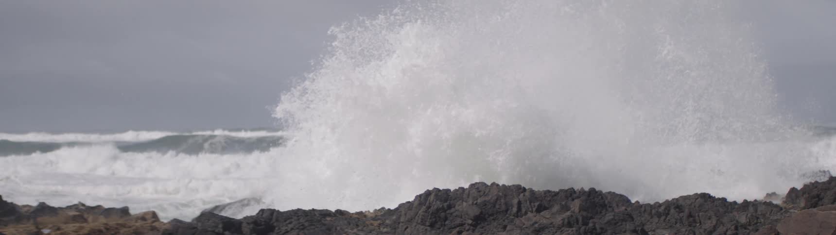 A rugged shoreline with waves crashing against the rocks