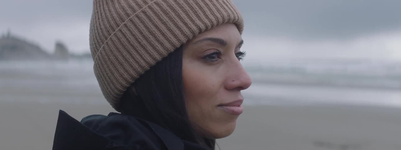 A woman is looking over the beach