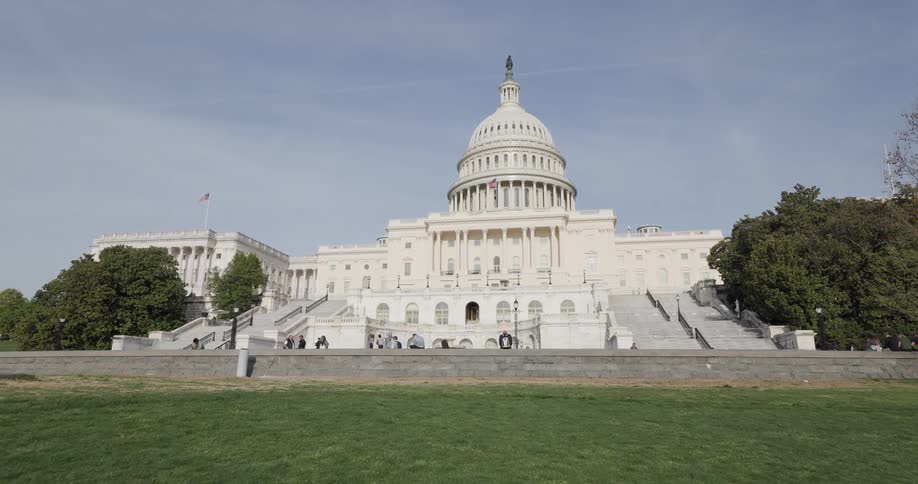 People walk past the capitol building