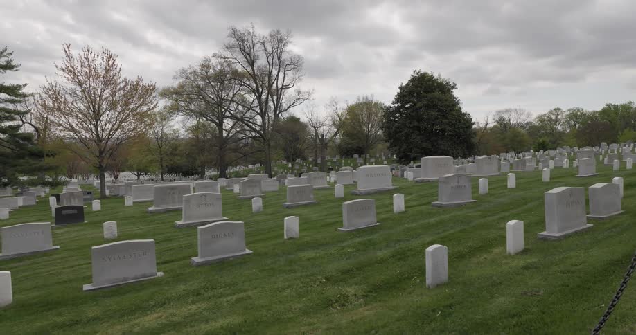 Cemetery with several marble tombstones on a cloudy day