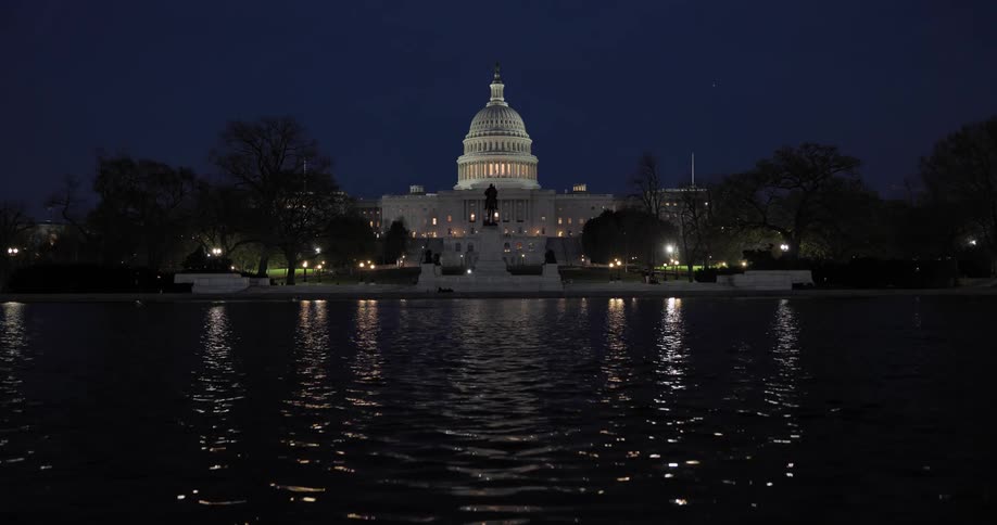 Panorama of the washington capitol near a lake at night