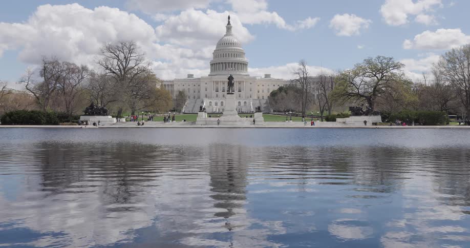 Panorama of the washington capitol in front of a calm lake during the day