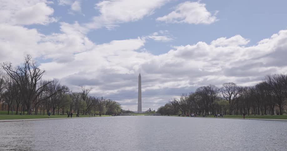 Panorama of a lake in a park with the washington obelisk in the background