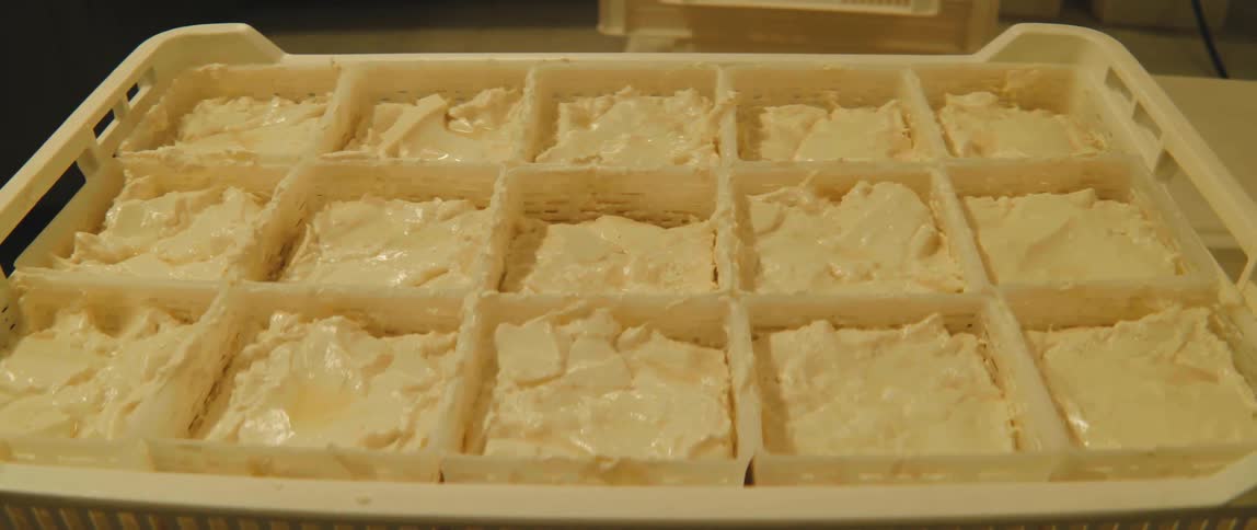 A tray of butter sitting on a table