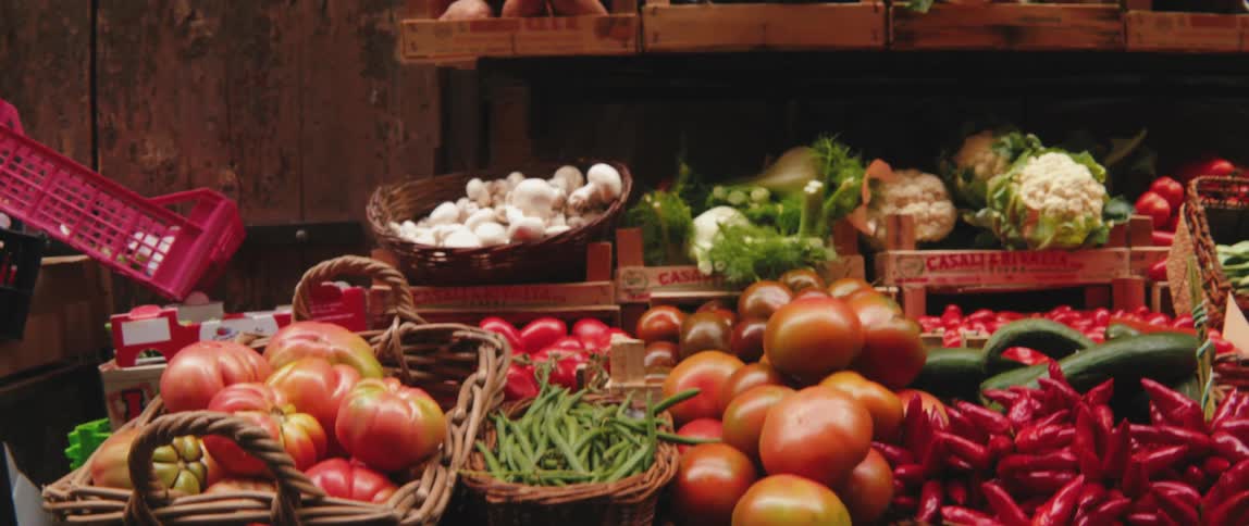 Baskets with various vegetables for sale in a grocery store